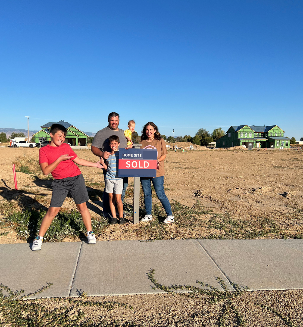 Family at lot before breaking ground on future dream home in Treasure Valley